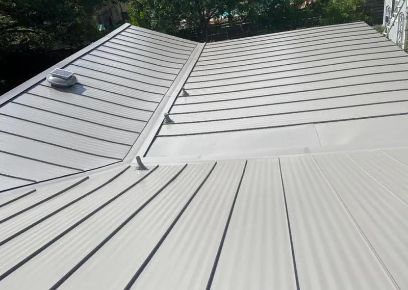 Solar attic fan installed on a metal roof for Roof Ventilation in Patchogue
